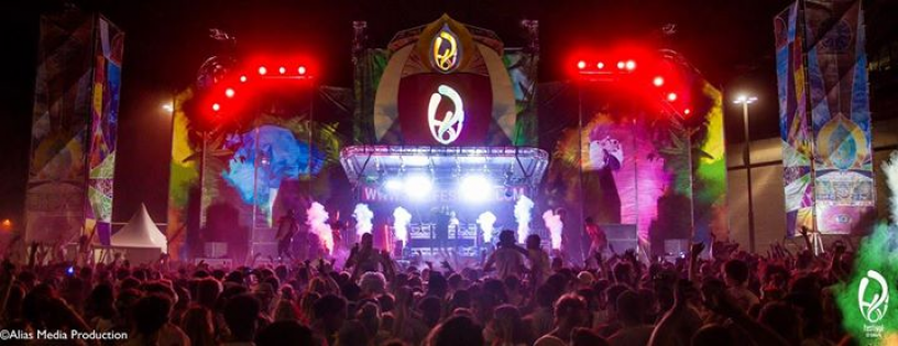 Crowd watching a DJ perform on stage at the festival