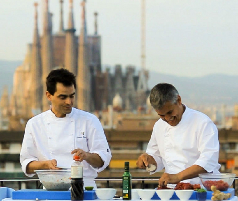 Cooks on a terrace with the Sagrada Familia in the background