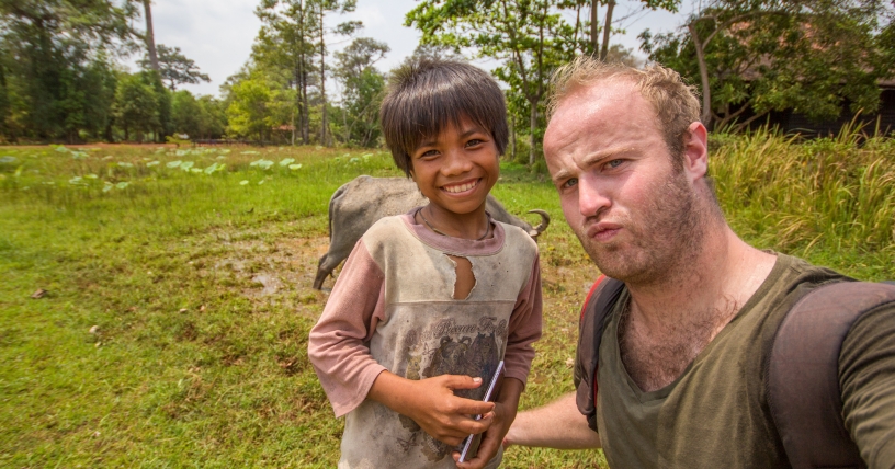 Brendan meeting a local child in Cambodia