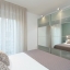 Double bedroom with glass-door wardrobe